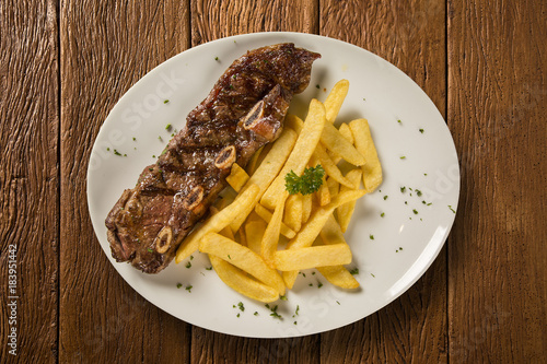 Ribs streak with french fried. A rib steak is a beef steak sliced from the rib primal of a beef animal, with rib bone attached.