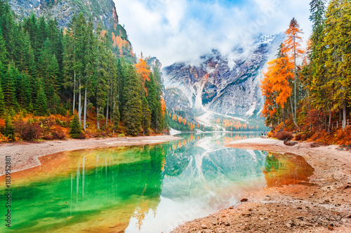 Lake Braies iconic natural landmark in Italy, South Tyrol Dolomites alpine region. Beautiful autumn scenery of captivating incredible Lake Braies in italian Dolomite Alps mountains. Forest on banks.