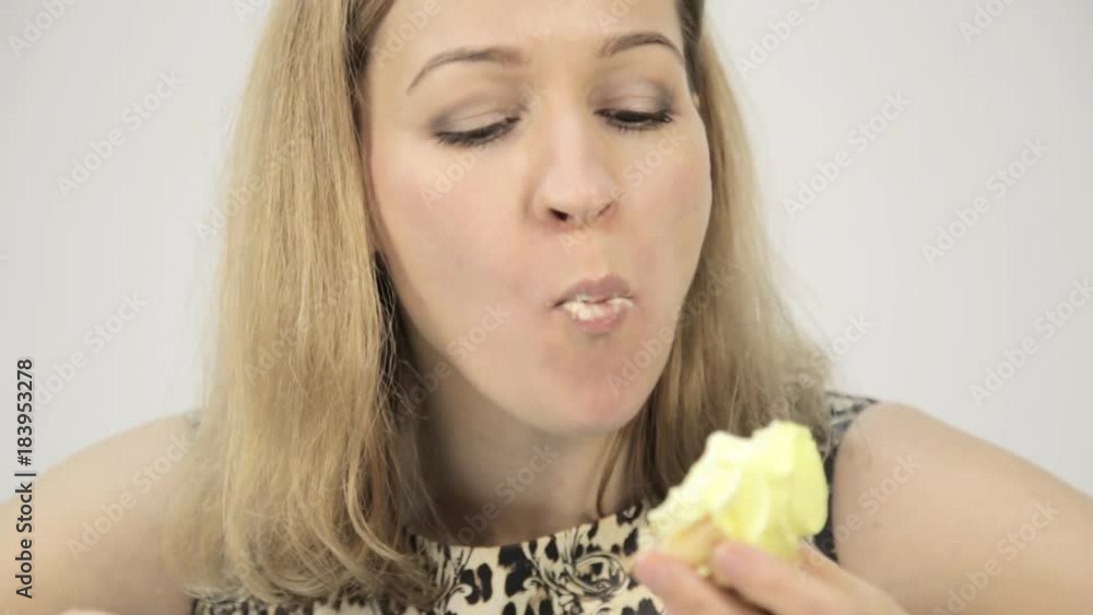 close-up woman eating cupcakes with frenzy after debilitating diet close-up woman eating cupcakes with frenzy after debilitating diet