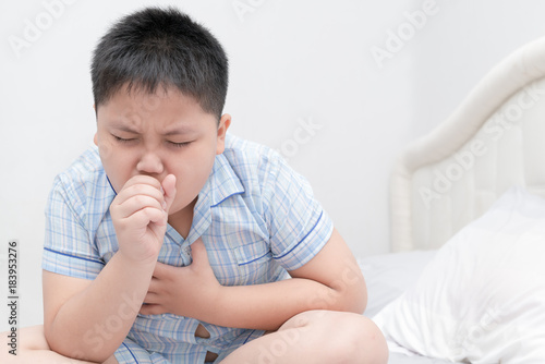 Картината върху платно Sick obese boy is coughing and throat infection