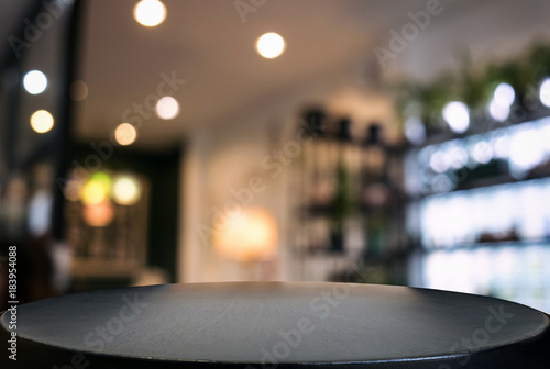 Empty wooden table and blurred background of abstract in front of restaurant or coffee shop for display of product or for montage