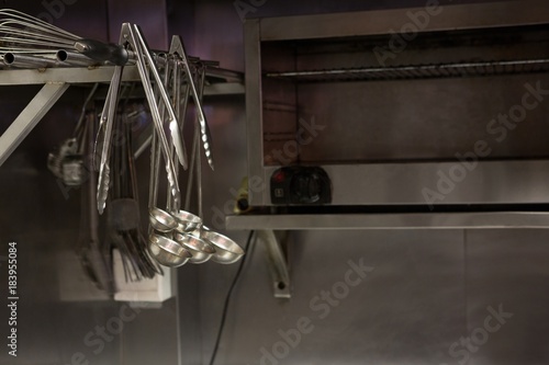 Tongs and oil dipper hanging on stand