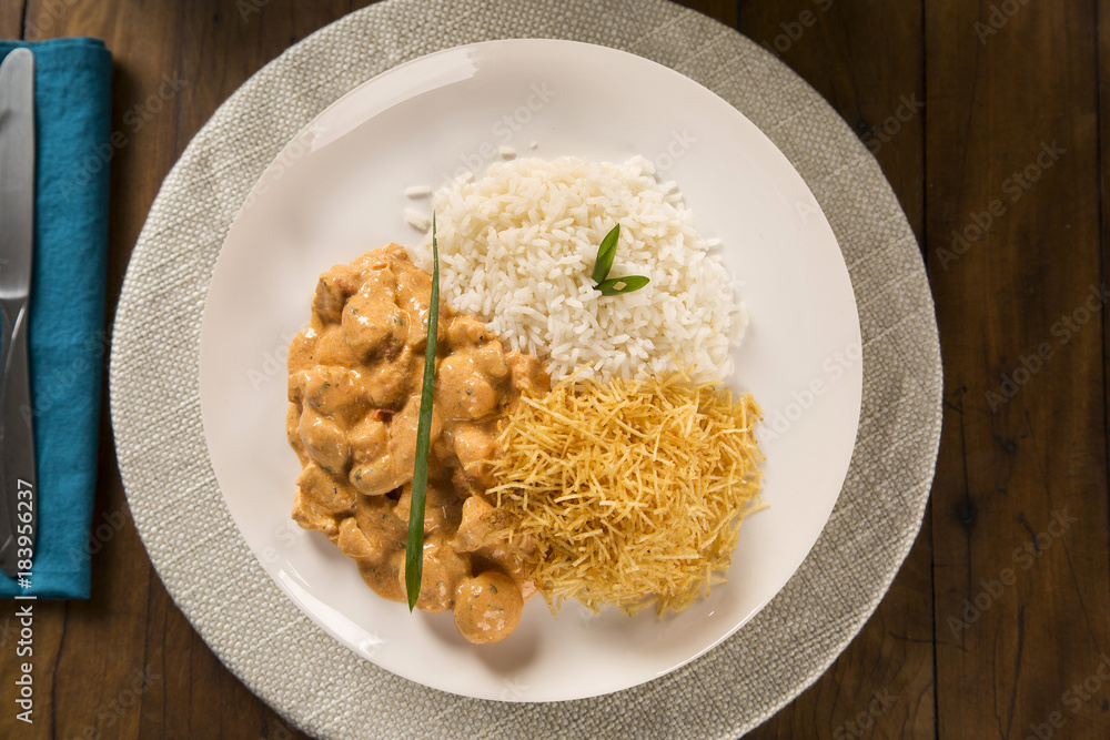 Delicious healthy food with chicken strogonoff with rice and french fries on dish. View from the top..