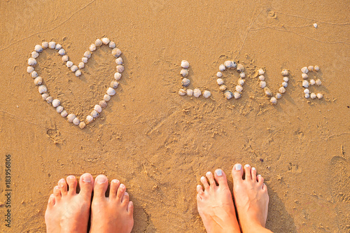 Feet of two lovers on sand-summer, sun, sea, beach, happy time photo