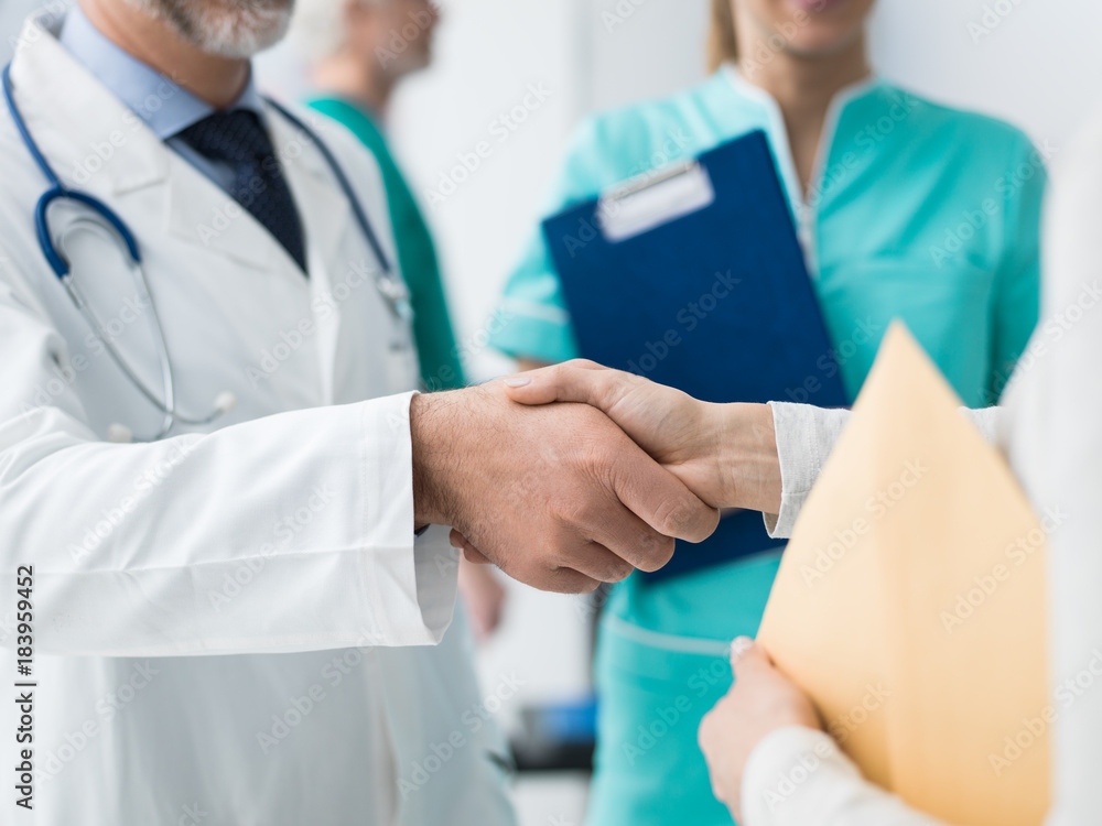 Doctor and patient giving an handshake Doctor and patient giving an handshake