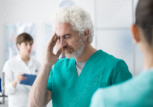 Wallpaper Mural Healthcare worker having an headache Torontodigital.ca