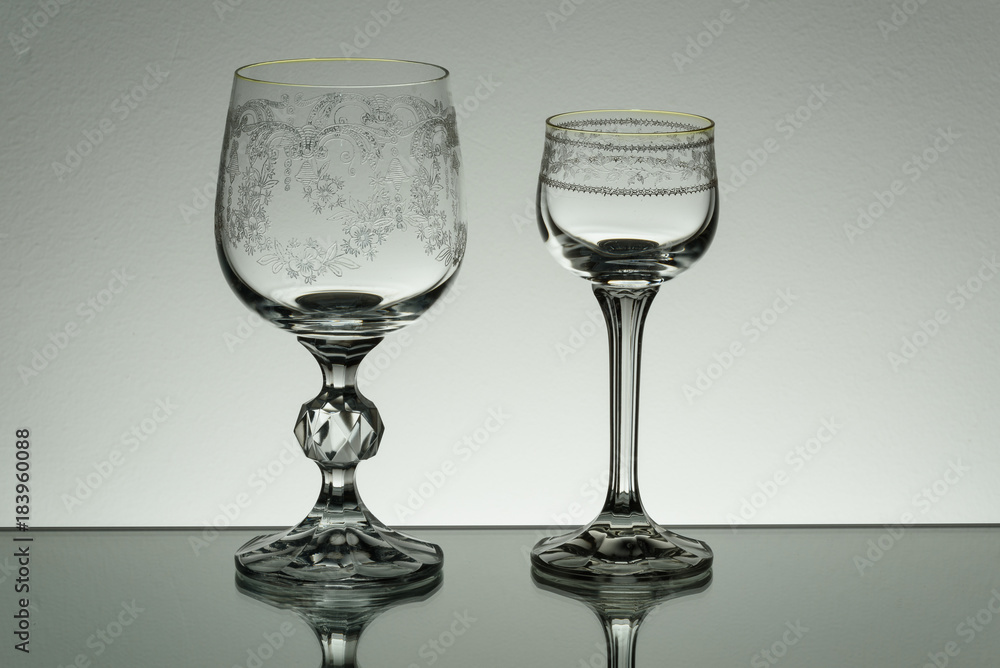 Crystal glass illuminated on mirror and black background Crystal glass illuminated on mirror and black background