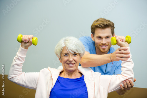 senior female working with physiotherapist