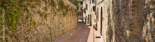 wide panorama on the street with old walls in Tuscany in Italy © sergejson