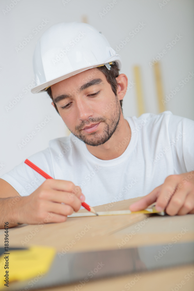 man measuring a plank man measuring a plank