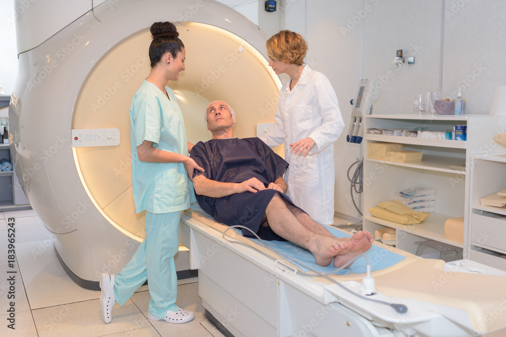 nursing staff talking to patient at ct-scanner nursing staff talking to patient at ct-scanner