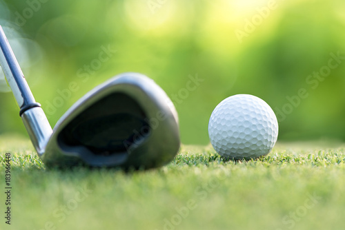 Golf club hitting golf ball along fairway towards green with copy space, green nature background. Lifestyle Concept. select focus