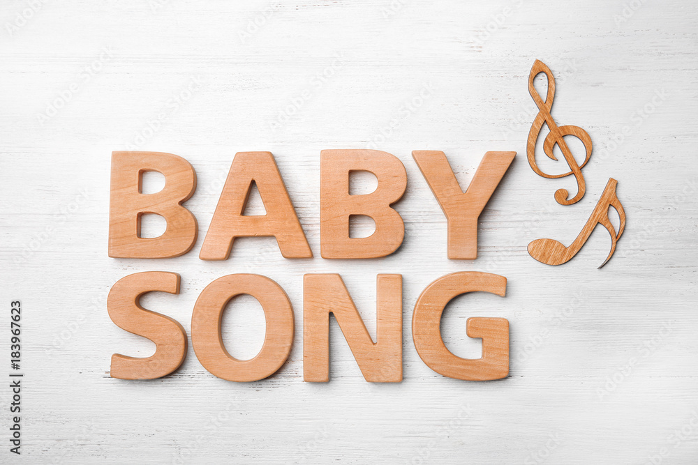 Text BABY SONG made of letters on wooden background Text BABY SONG made of letters on wooden background
