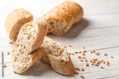 Yummy fresh bread on wooden background