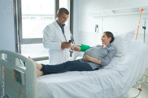 woman lying on the hospital bed in the ward