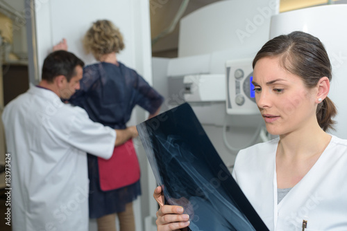 female patient standing for an xray exam