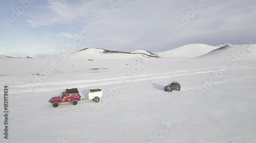 360 aerial, cars drive off road in snowy Iceland aerial