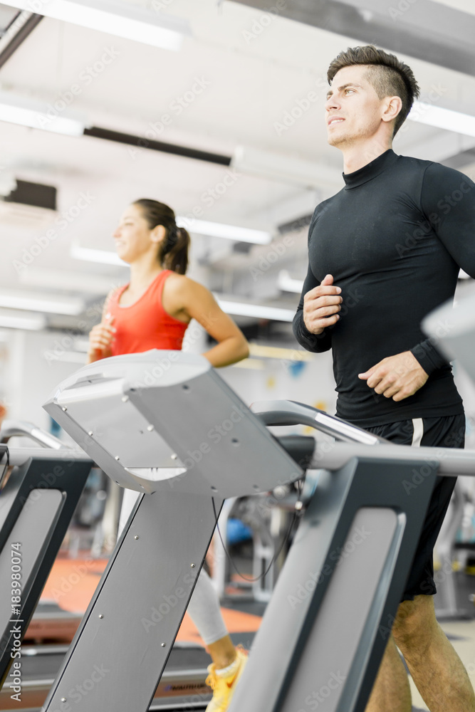 Group of young people using treadmills in a gym Group of young people using treadmills in a gym
