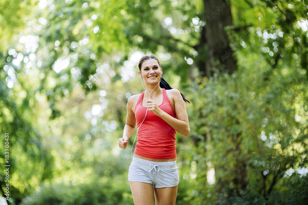 Young beautiful athlete jogging in park Young beautiful athlete jogging in park