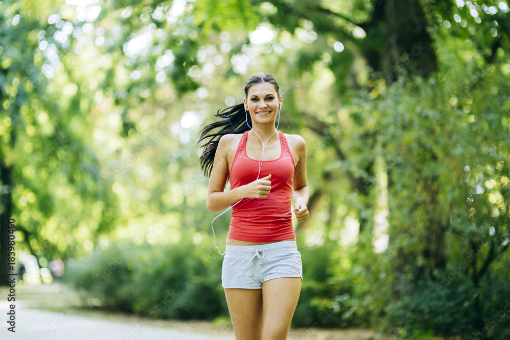 Young beautiful athlete jogging in park Young beautiful athlete jogging in park
