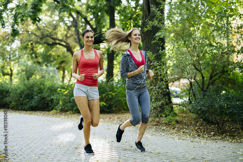 Fototapeta Naklejka Na Ścianę i Meble -  Young fit women jogging outdoors