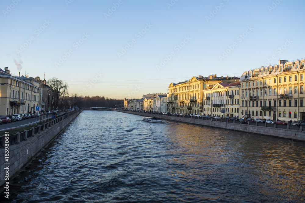 Embankment of Fontanka river in the autumn in the rays of light in Saint Petersburg