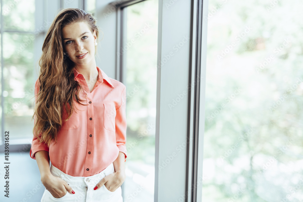 Fototapeta premium Beautiful businesswoman with hands in pockets
