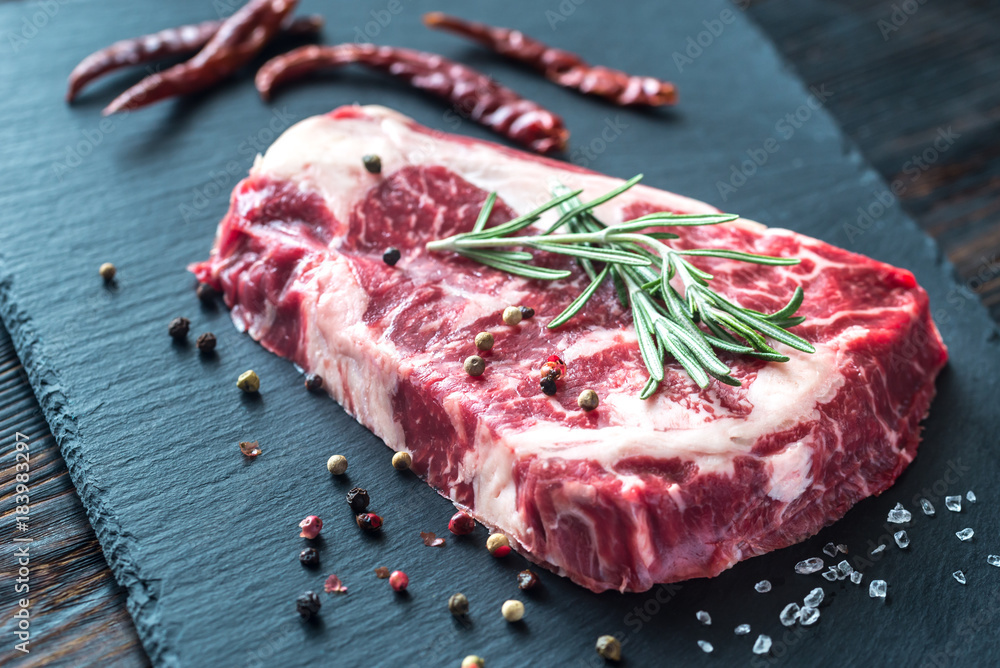 Raw beef steak with fresh rosemary