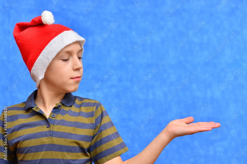 Cute little boy in Santa hat on color background Cute little boy in Santa hat on color background