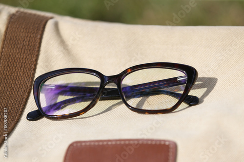 Eyeglasses lying on the brown bag
