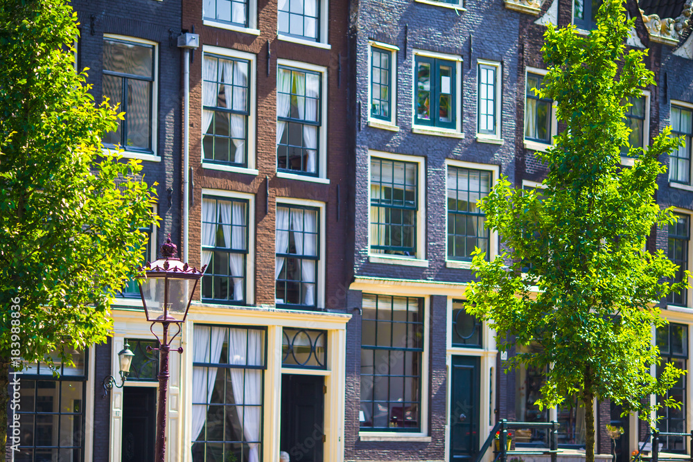 Fototapeta premium Traditional dutch buildings and blocks of flats in in old Amsterdam, Netherlands