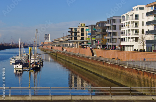 Waterfront of the Europa harbor in Bremen, Germany with moored sailing yachts and modern office and luxury apartment buildings