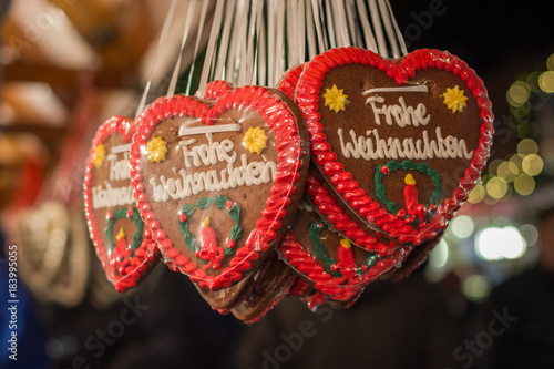 Several gingerbread hearts with Merry Christmas in German at a Christmas market