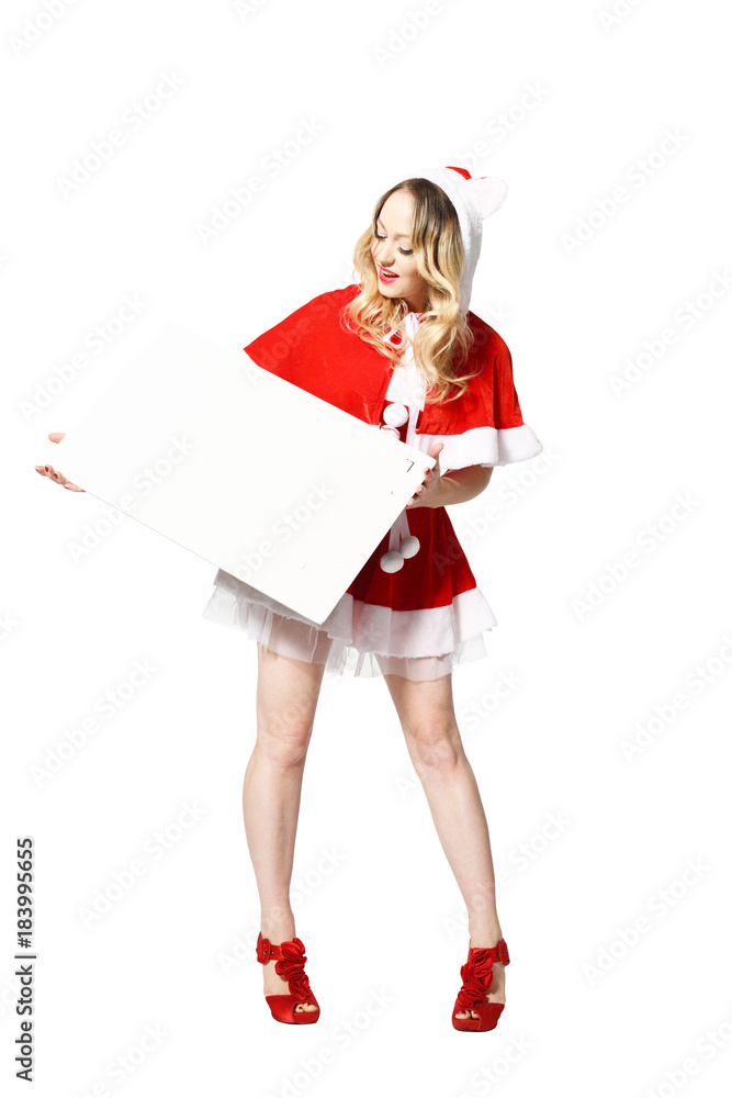 Blonde Weihnachtsfrau mit schöner Mimik präsentiert ein Schild für Textfreifläche Blonde Weihnachtsfrau mit schöner Mimik präsentiert ein Schild für Textfreifläche
