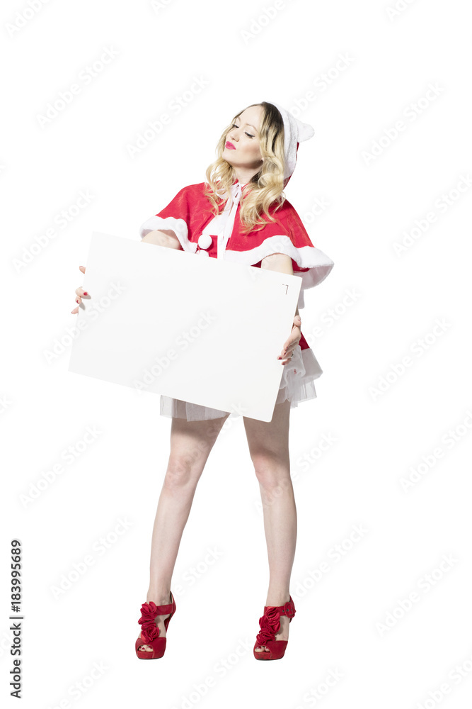 Blonde Weihnachtsfrau mit schöner Mimik präsentiert ein Schild für Textfreifläche Blonde Weihnachtsfrau mit schöner Mimik präsentiert ein Schild für Textfreifläche