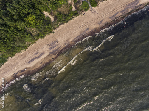 Aerial view over a Baltic Sea shore line in Karkle near Klaipeda city, Lithuania. During sunny summer day. photo