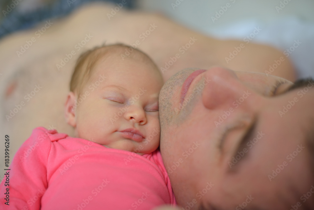 A newborn girl falls asleep on her father A newborn girl falls asleep on her father