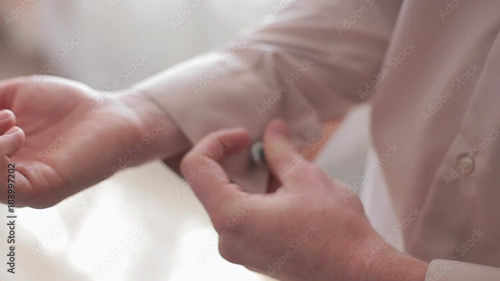 Man wears shiny cufflinks. Close up Man wears shiny cufflinks. Close up