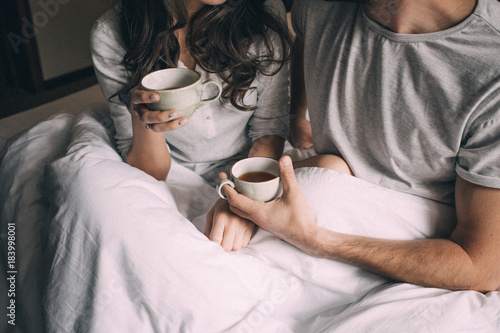 lovers holding together a Cup of tea