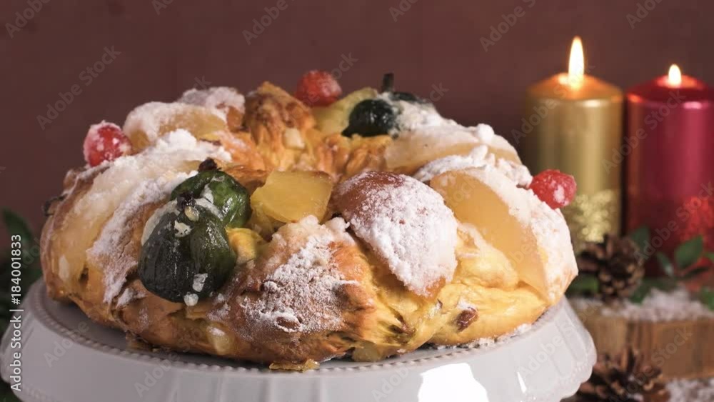 Bolo do Rei or King's Cake, Made for Christmas, Carnavale or Mardi Gras with Present Wrapping in Background Bolo do Rei or King's Cake, Made for Christmas, Carnavale or Mardi Gras with Present Wrapping in Background