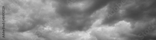 Thunderclouds over horizon, cloudscape, storm. Panorama of a gray gloomy sky.