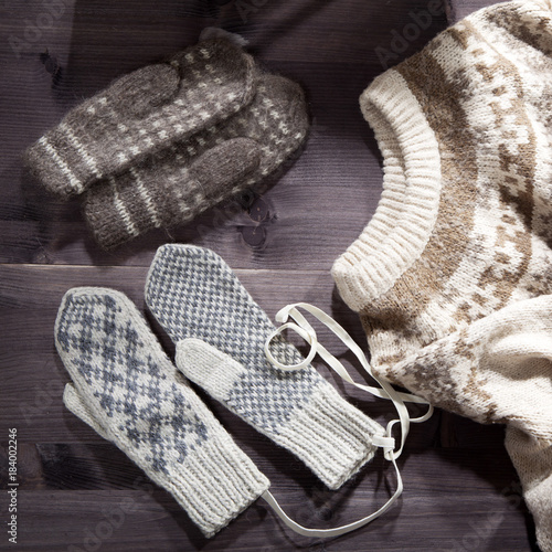 the Woolen mittens, scarf and sweater lie on the table. Copy space.
