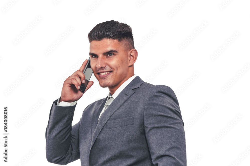 A handsome businessman in an elegant suit with a mobile phone in his hand. A handsome businessman in an elegant suit with a mobile phone in his hand.