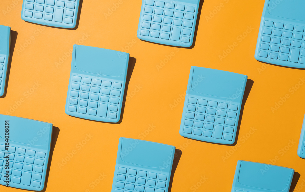 Blue pocket calculators on orange background. Blue pocket calculators on orange background.