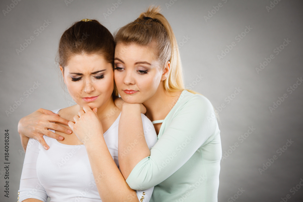 Woman hugging her sad female friend Woman hugging her sad female friend