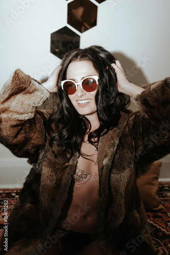 Fashion young woman wearing fur jacket 70s glam New Years Party