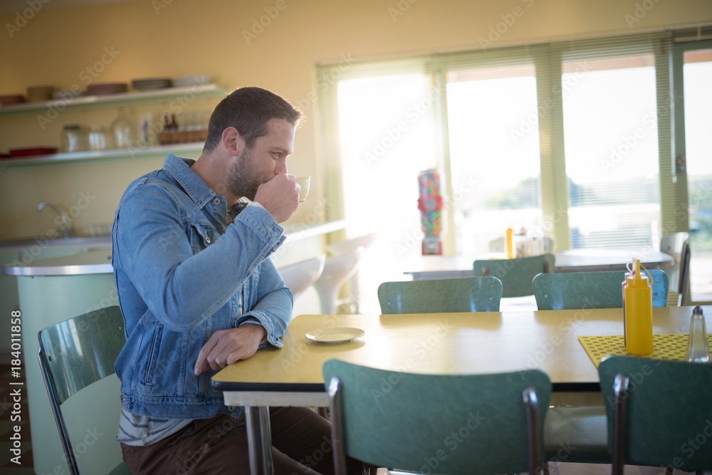 Man having coffee in restaurant Man having coffee in restaurant