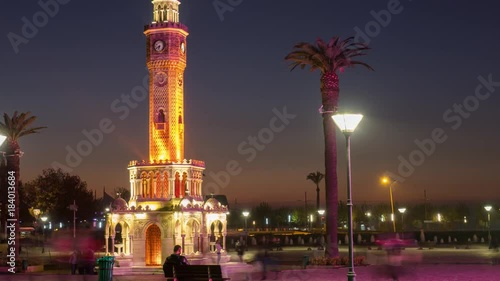 People near clock tower of Izmir at evening timelapse, Turkey photo