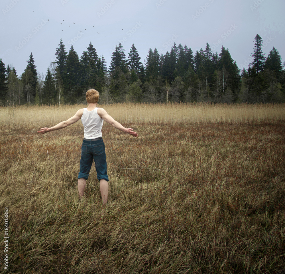 guy standing in field, arms outstretched guy standing in field, arms outstretched