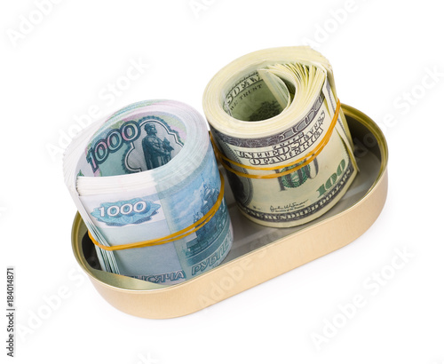 bundles of US dollars and russian rubles in can